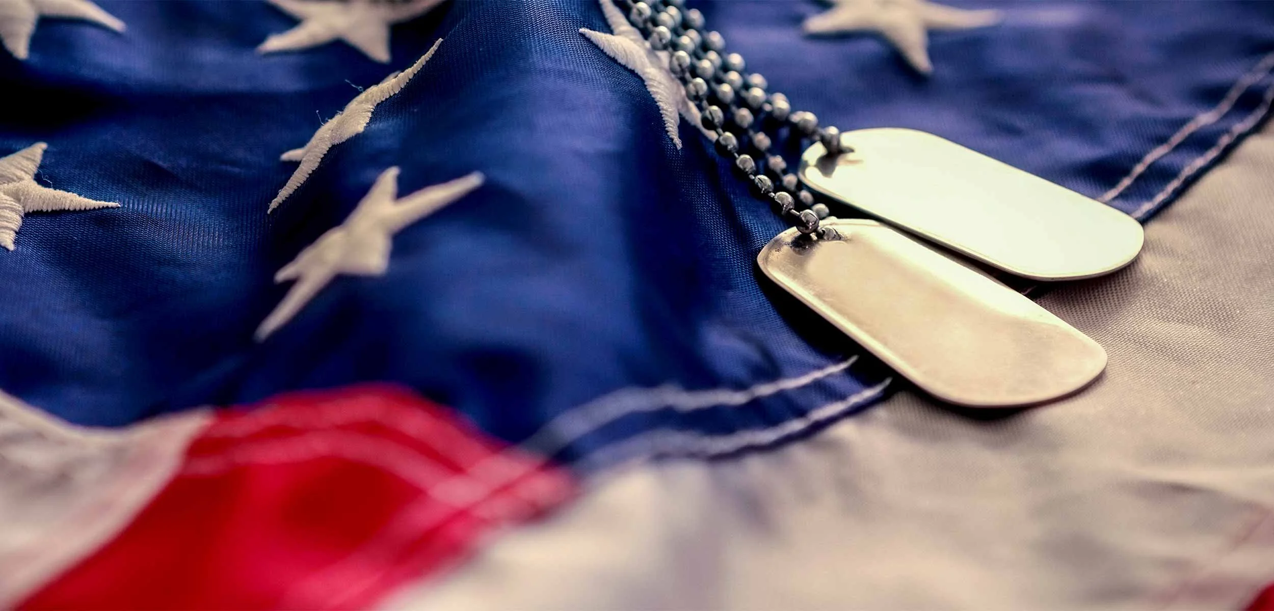 American Flag with military dog tags lying on top of it