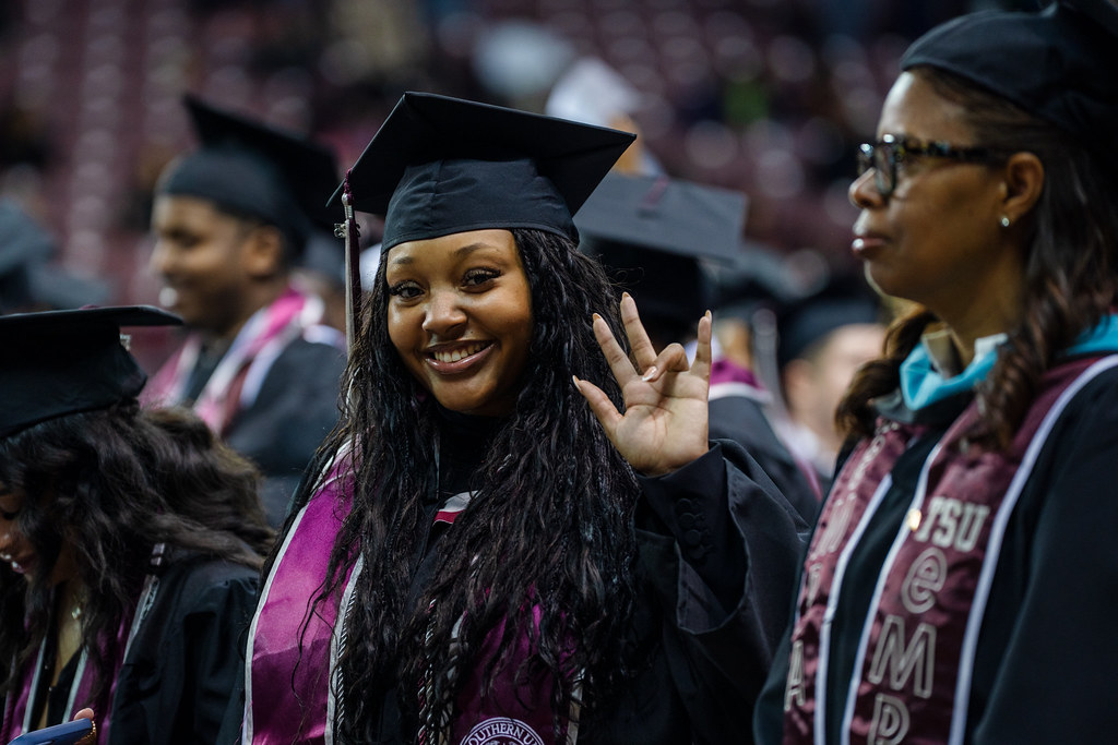 Graduate Female at Graduation Showing Tiger Sign