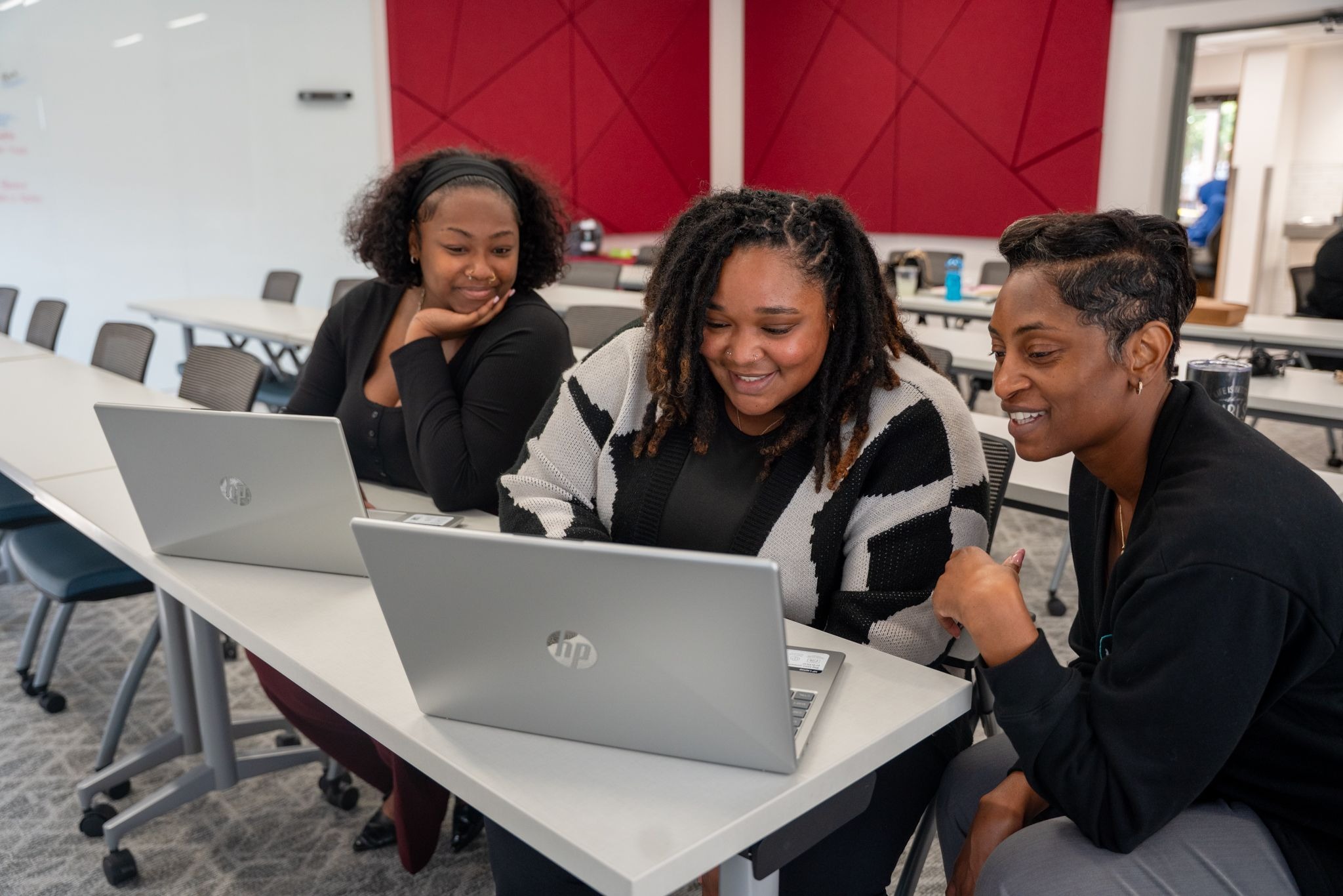 Three females looking at a computer